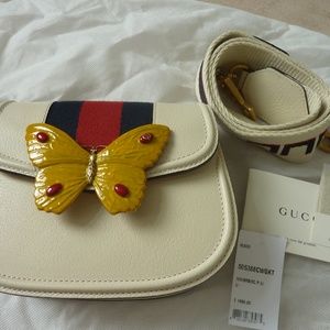 white gucci bag with butterfly